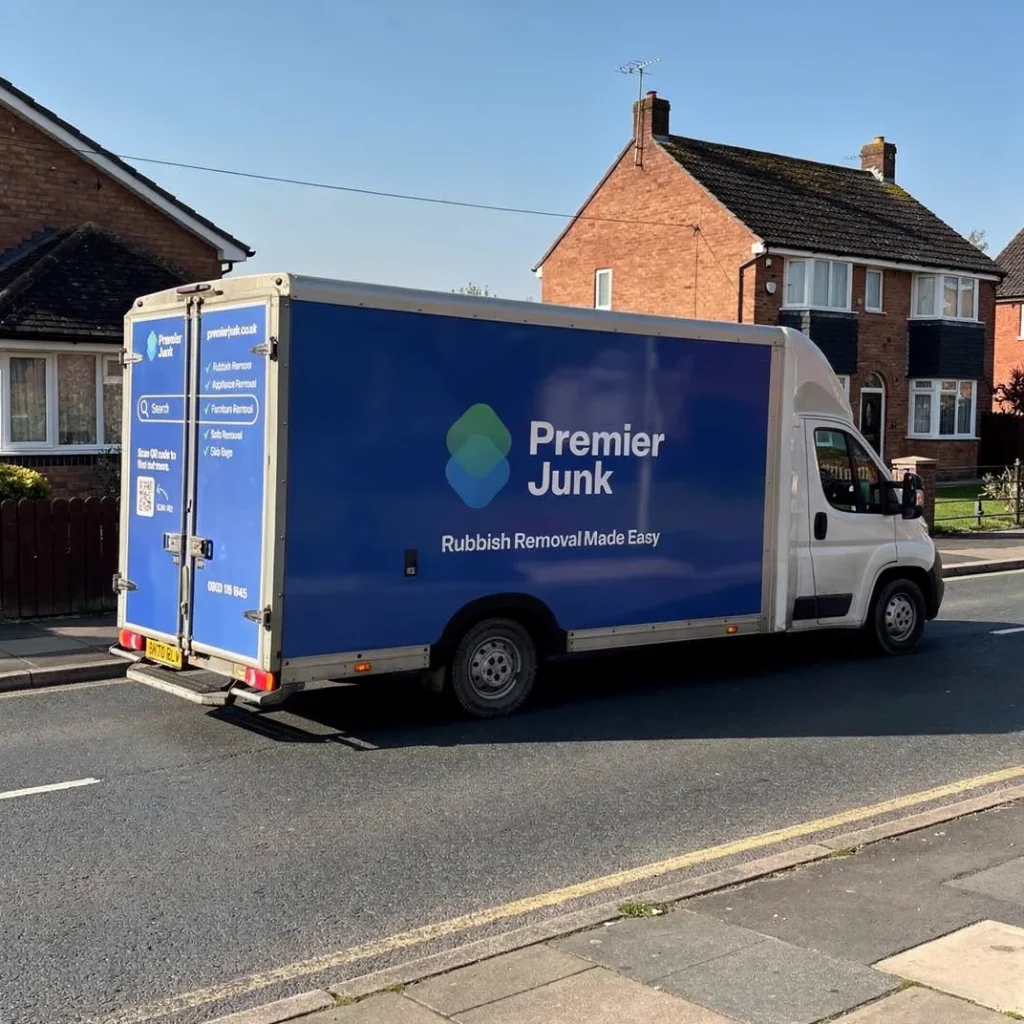 Premier junk van driving through residential street in Ferndown